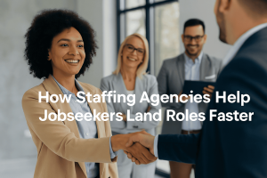 a photo of a modern Canadian office. A recruiter is reviewing resumes at a desk with a laptop and shaking hands with a candidate. Clean design with blue and neutral tones, optimized for a professional blog.